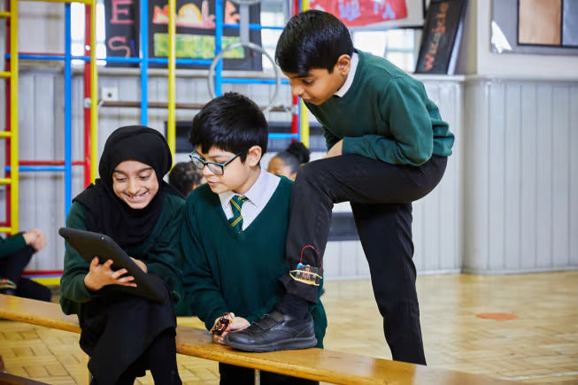 Three students using an ipad to program a micro:bit step counter