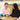 Two students assembling a green robotics kit with wheels and circuit board | Forward Education