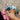 Child's hand holding blue micro:bit device with LED grid display outdoors | Forward Education