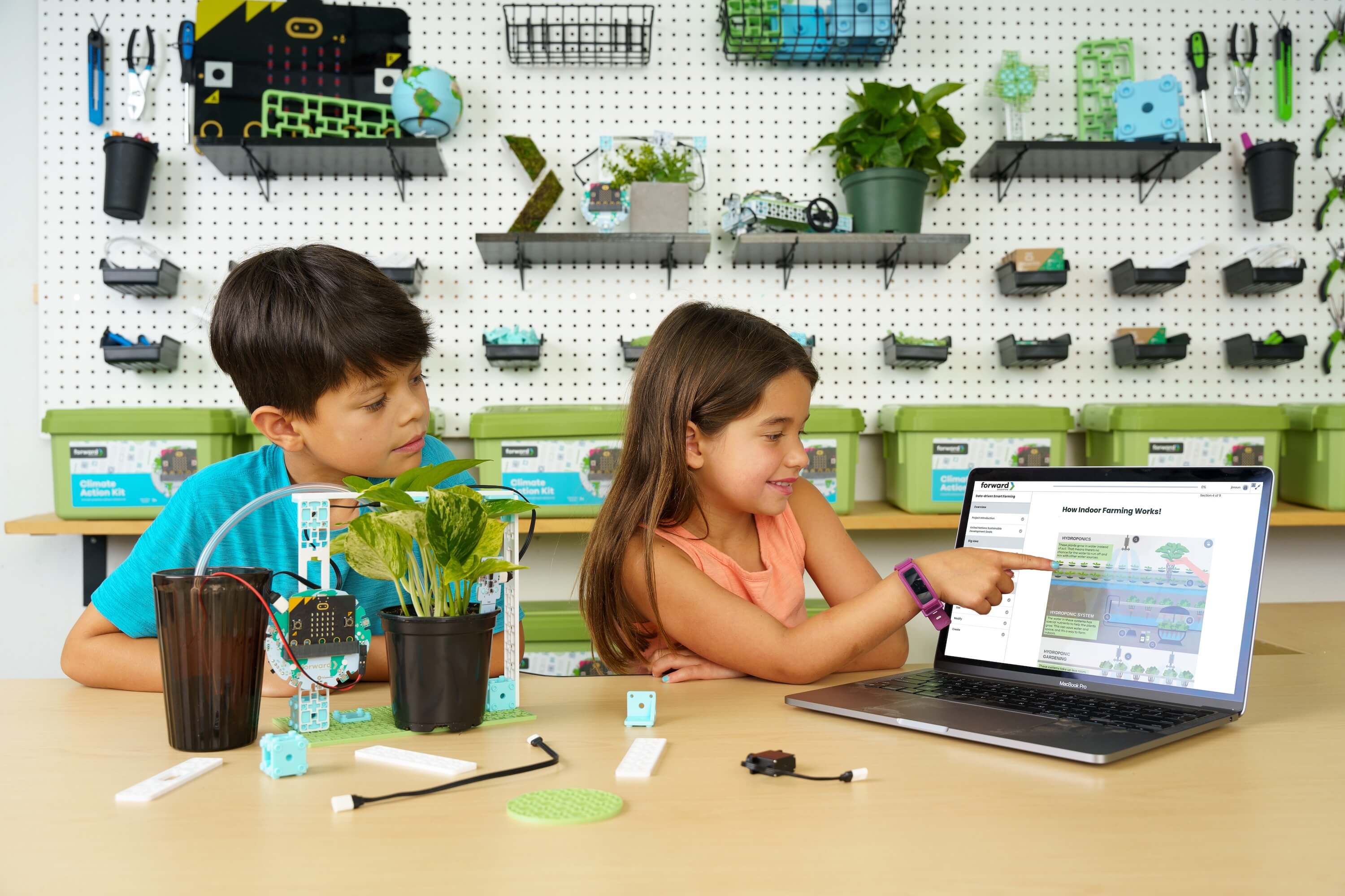 Two students looking at the lesson content on a computer for the Smart Farming lesson in the Climate Action Kit