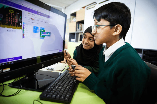 Two students using micro:bit and Makecode