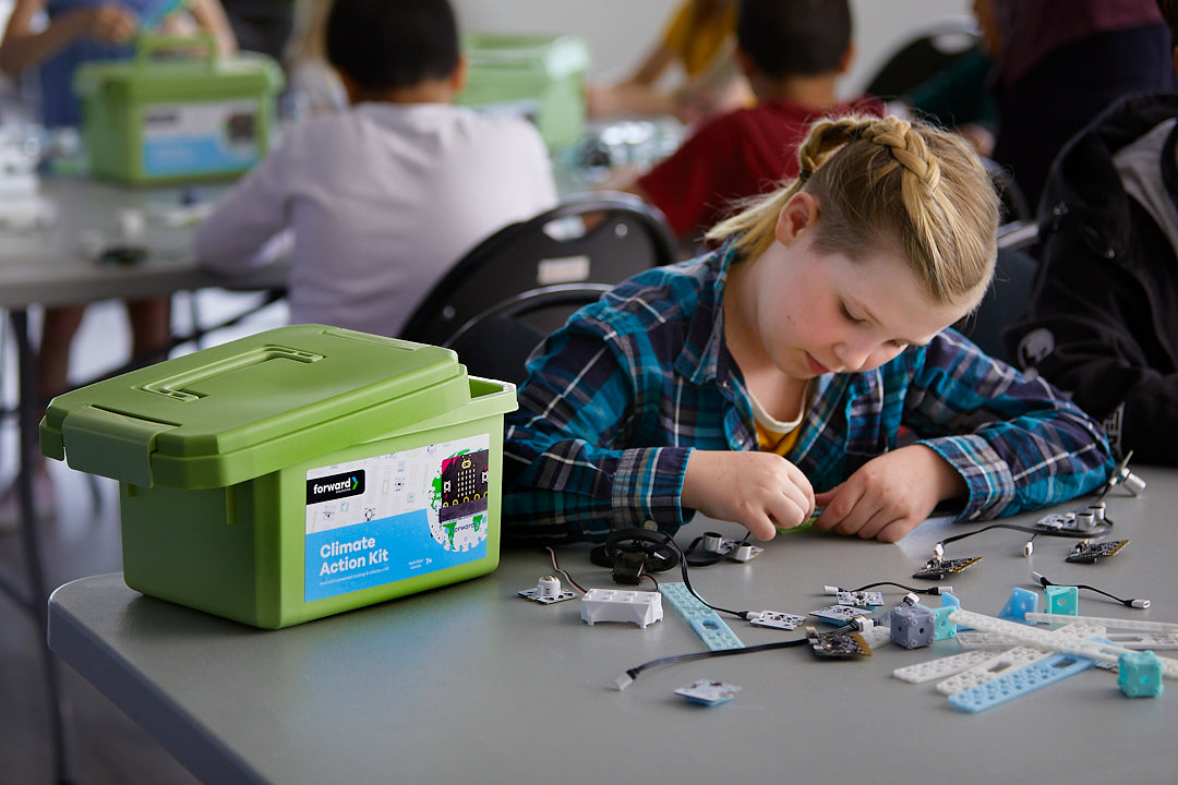 Female student working with various Climate Action Kit pieces