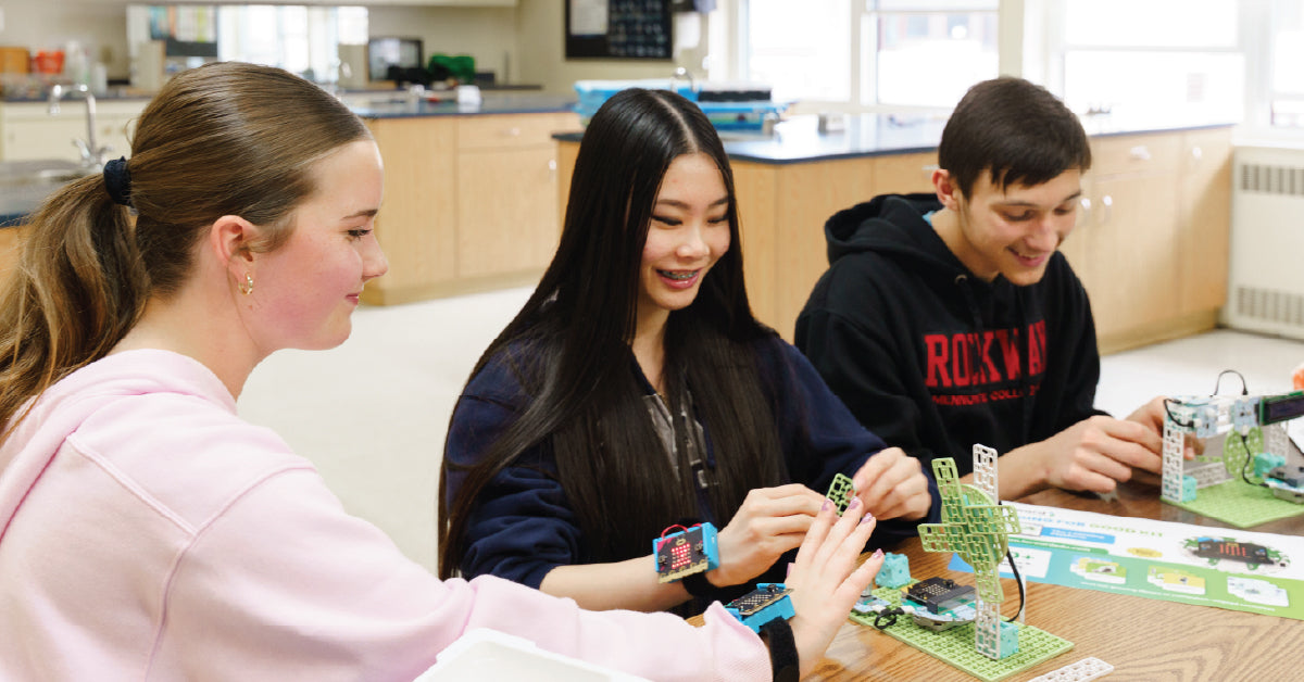 Students building with colorful circuit boards and wearable tech in classroom | Forward Education