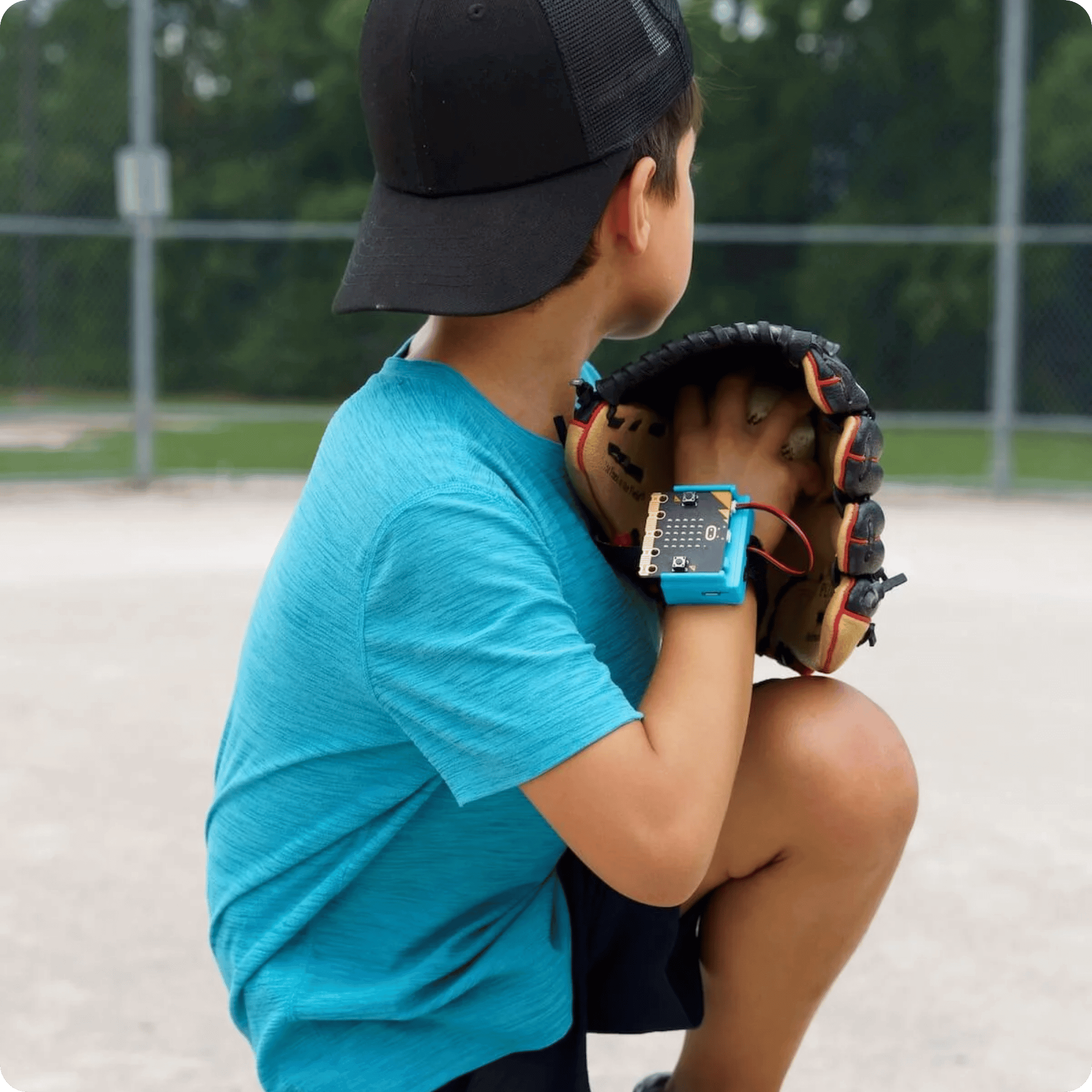 Image of a boy with CHARGE for micro:bit on his wrist throwing a baseball