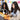 Students building with white robotics kit and headphones in classroom setting | Forward Education