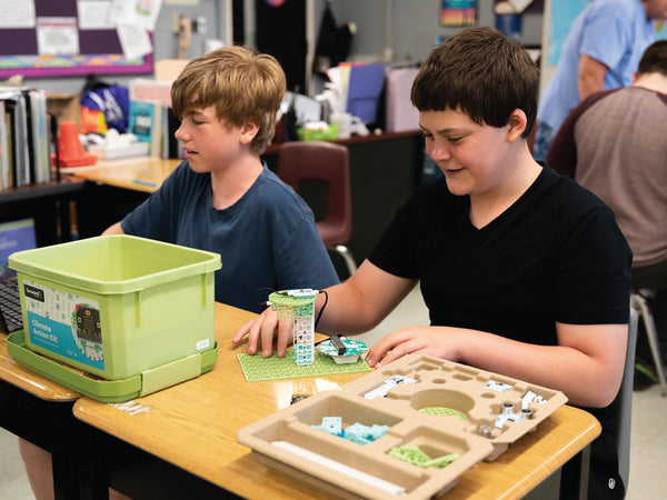 Climate action kit with green storage bin and wooden organizer tray in classroom setting | Forward Education
