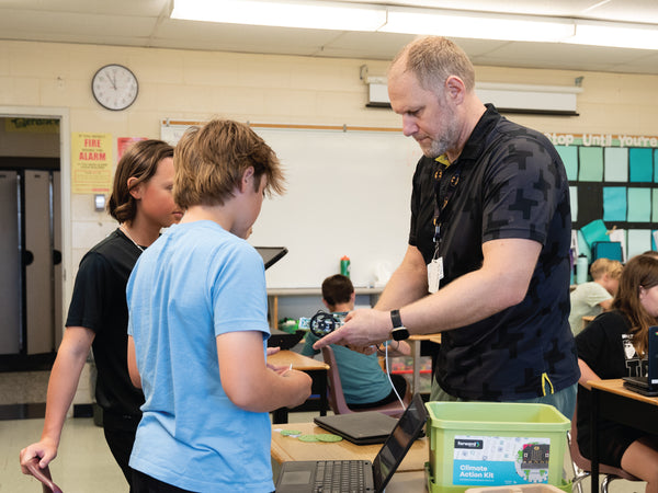 Educator demonstrating Climate Action Kit microcontroller to students in classroom setting | Forward Education