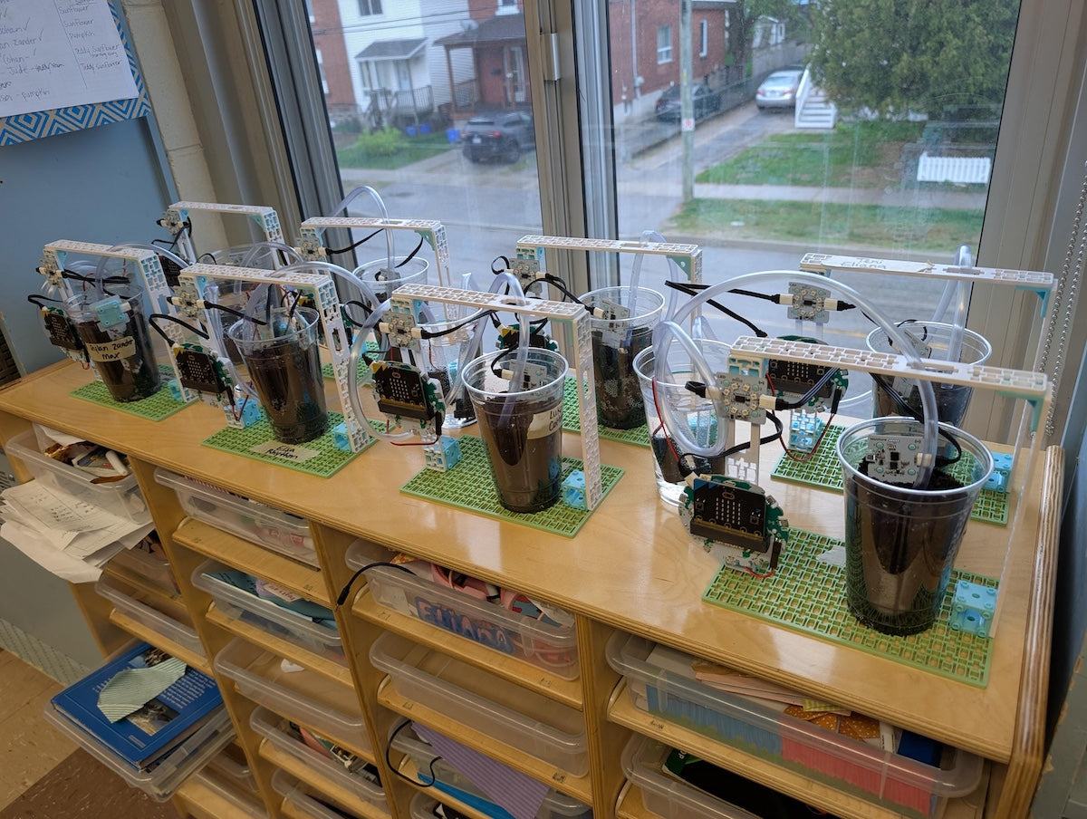 Several Smart Farming projects from the Climate Action Kit lined up on a window ledge